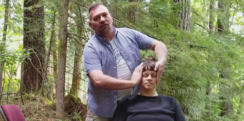 chair-Reiki-cemonstration Brian Brunius demonstrated how to perform Reiki on a student seated in a chair