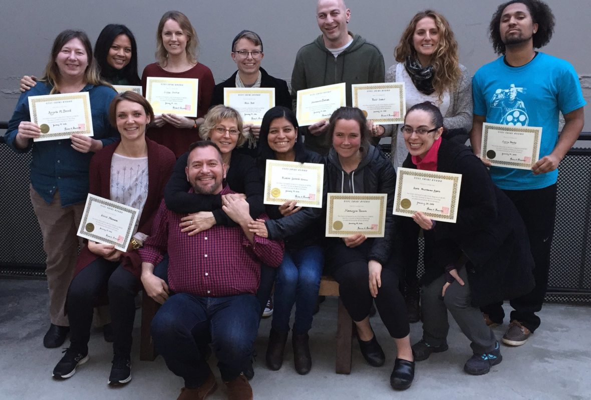 Reiki Master Brian Brunius with students holding their Reiki certificates at the completion of class.