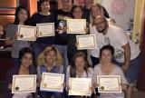 Reiki Master Brian Brunius with students holding their Reiki certificates at the completion of class.
