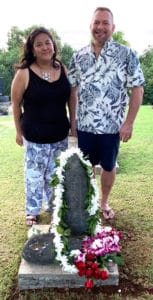 Photo of Diane Domondon and Brian Brunius standing at the grave and memorial stone of Reiki Grandmaster Phyllis Lei Furumoto in Kauai, Hawaii.