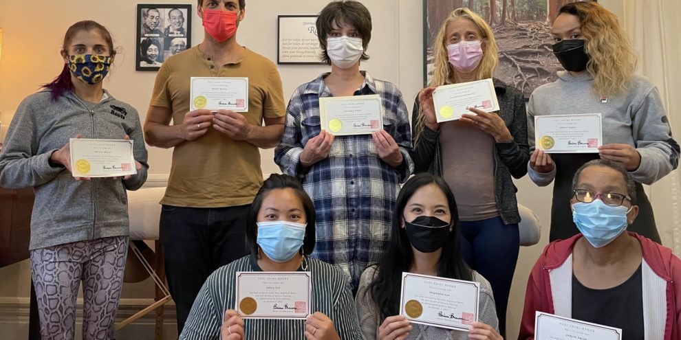Photo of Reiki students holding up their certificates at the end of the class. Photo of Reiki students holding up their certificates at the end of the class.
