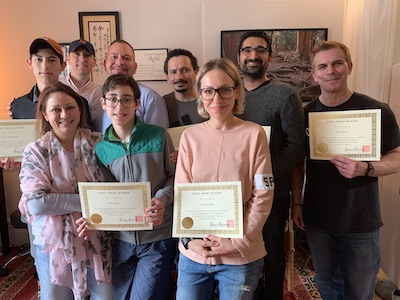 Brian Brunius with graduating students holding up their Reiki certificates after a level 1 class at the NYC Reiki Center in New York City.