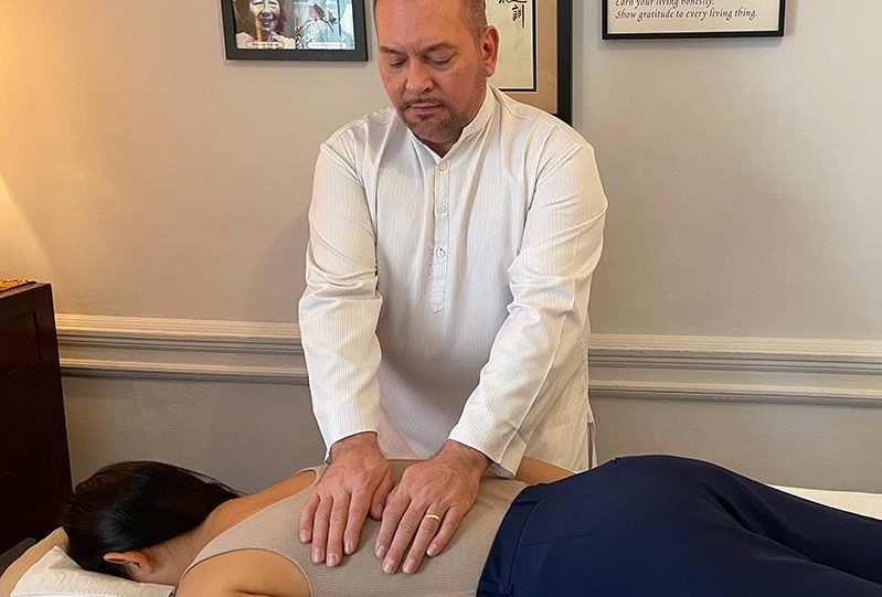 Reiki Master Brian Brunius delivering a Reiki treatment to a client