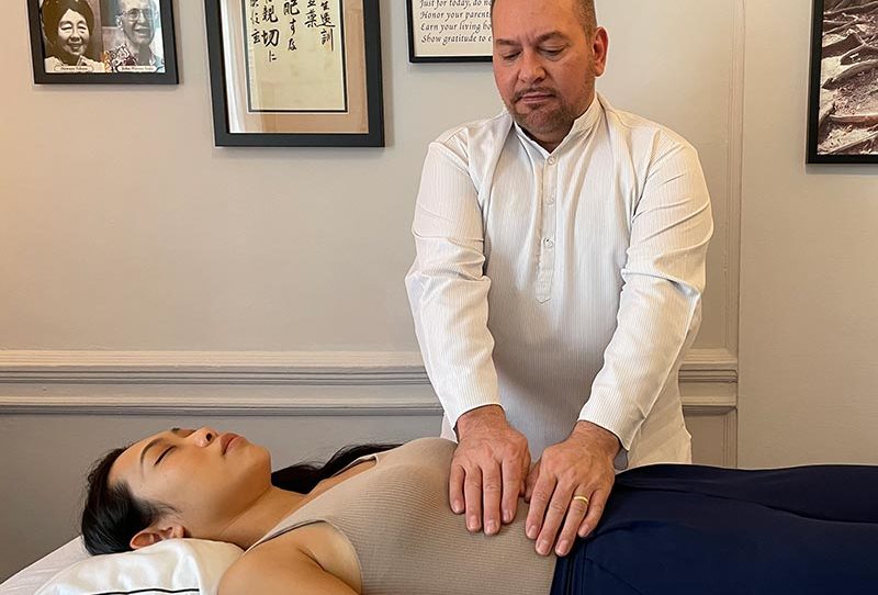 Reiki Master Brian Brunius delivering a Reiki treatment to a client