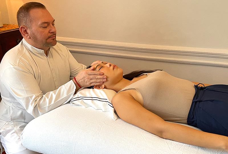 Reiki Master Brian Brunius delivering a Reiki treatment to a client