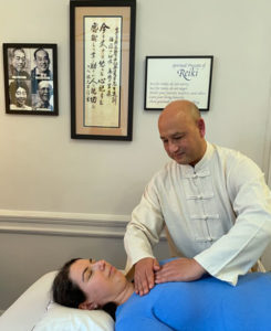 Photo of Reiki Master Simon Light giving a Reiki treatment to a client at the NYC Reiki Center