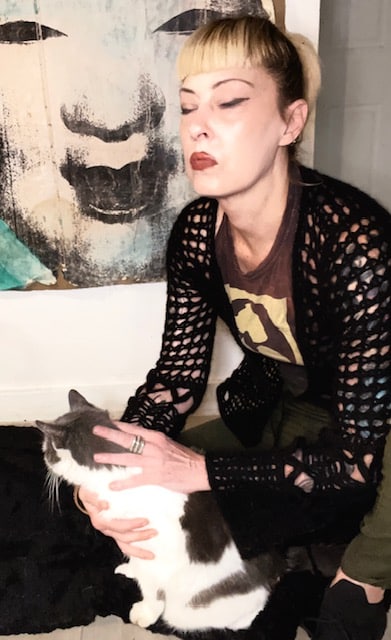 Photo of Victoria Wells giving Reiki to a cat