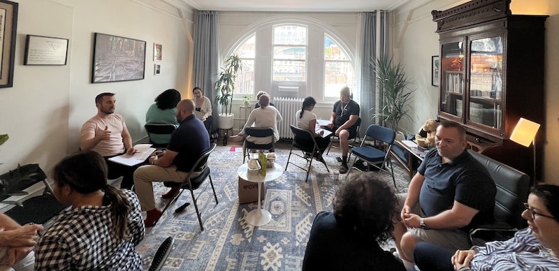 Photo of a Reiki Level 2 class at the NYC Reiki Center with students their skills with Master Brian Brunius