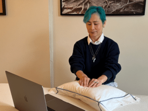 Photo of Yachi Gault, Reiki Master Practitioner, talking on Zoom to a client and delivering a Virtual Reiki Treatment