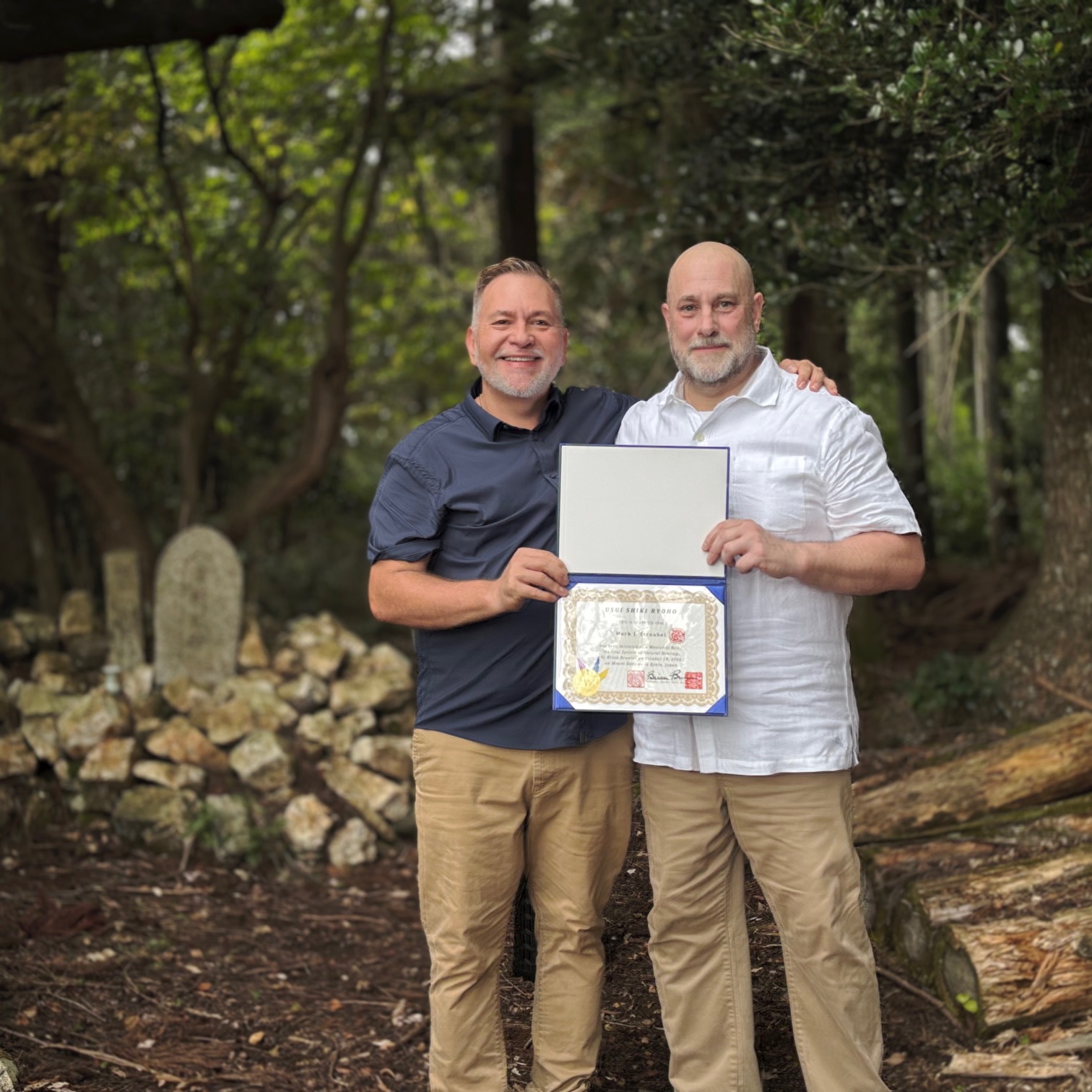 Brian Brunius and Mark Straubel holding Mark's Reiki Master certificate on Mount Kurama